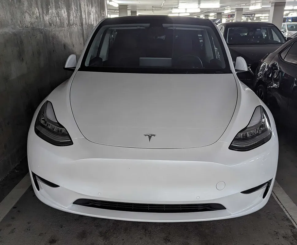 Image of front design of Tesla electric vehicle showing lack of grille elements